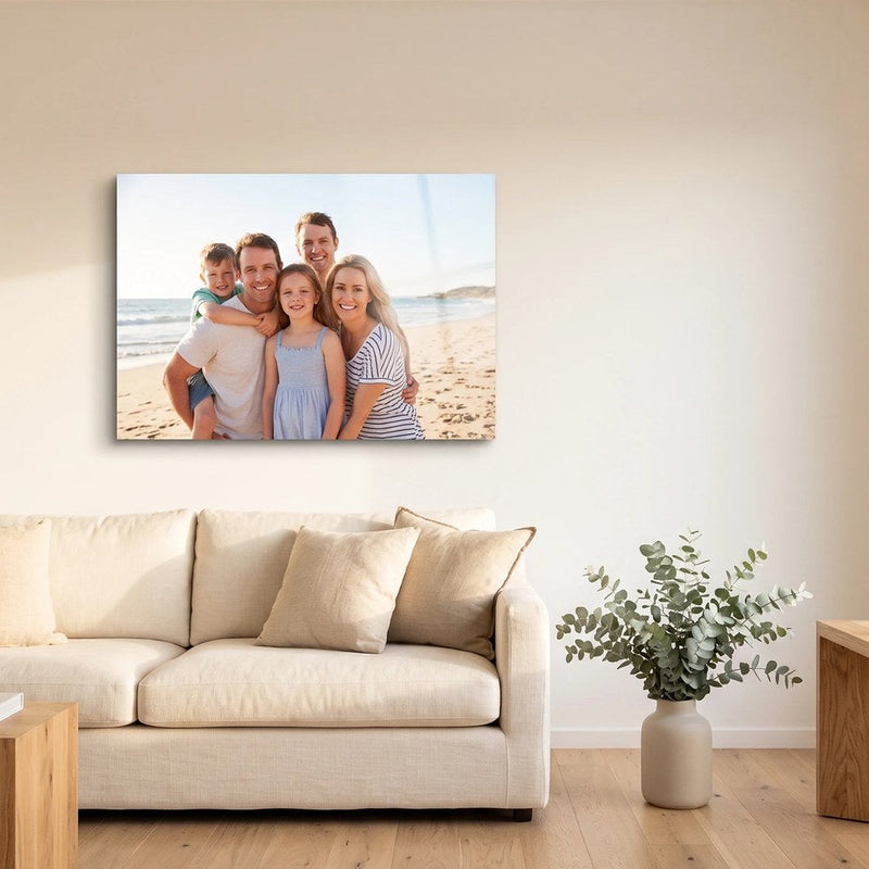 Personalised family beach photo printed on metal, hung above a sofa in a bright Australian living room