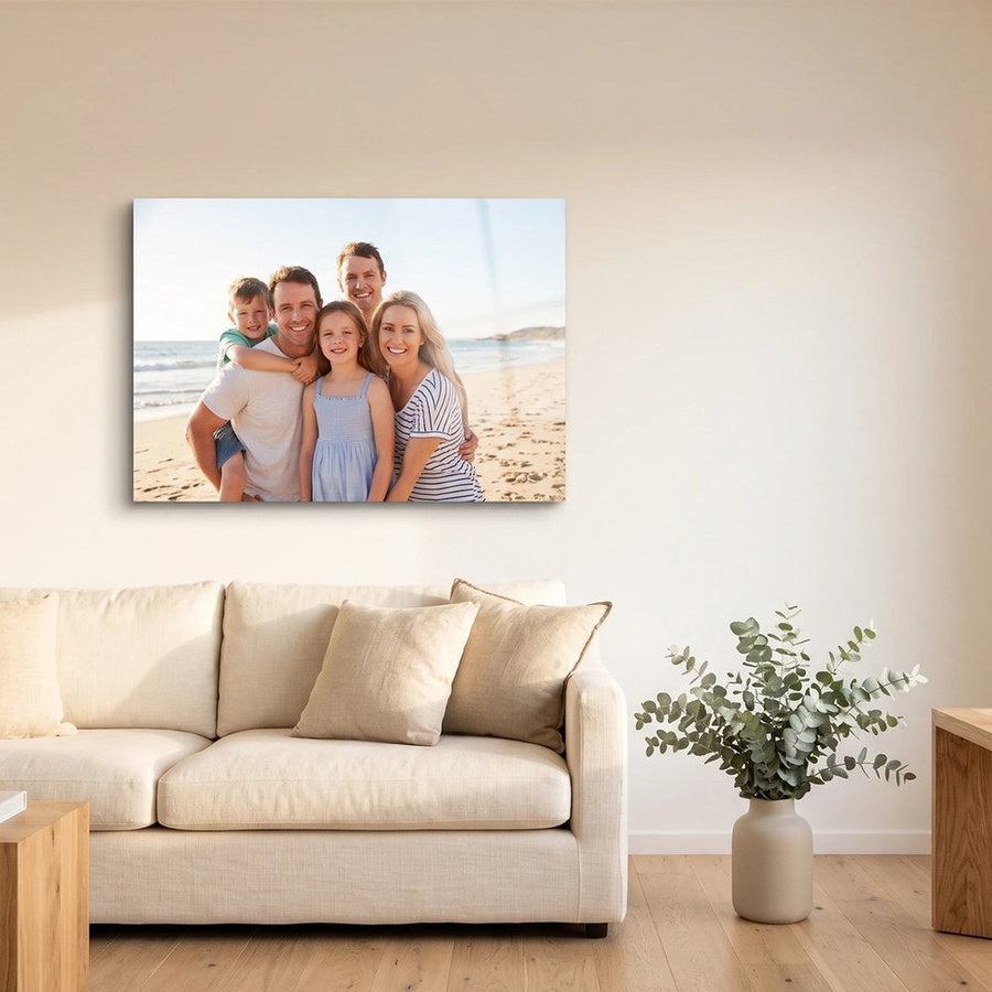 Personalised family beach photo printed on metal, hung above a sofa in a bright Australian living room
