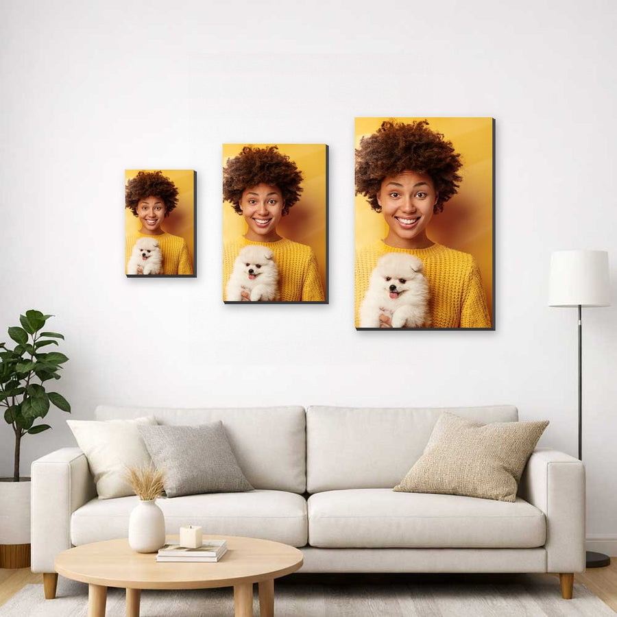 Three MagnetArt metal prints in small, medium and large sizes above a cream sofa